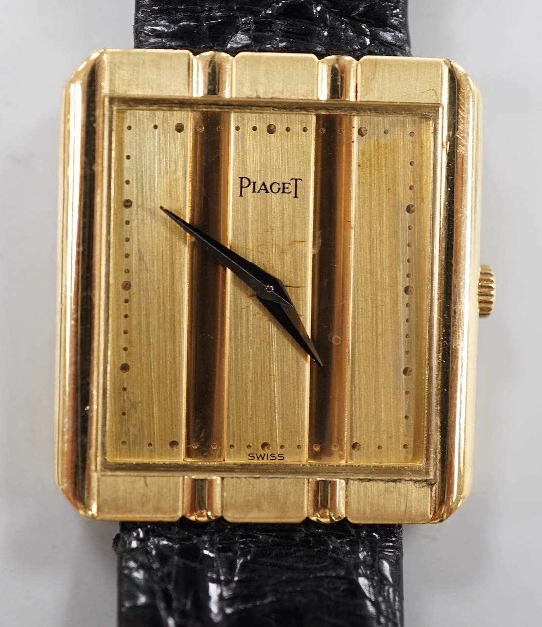 A gentleman's modern 18ct gold Piaget quartz dress wrist watch, with 'blind' rectangular dial, on associated leather strap, case diameter 26mm, no box or papers.